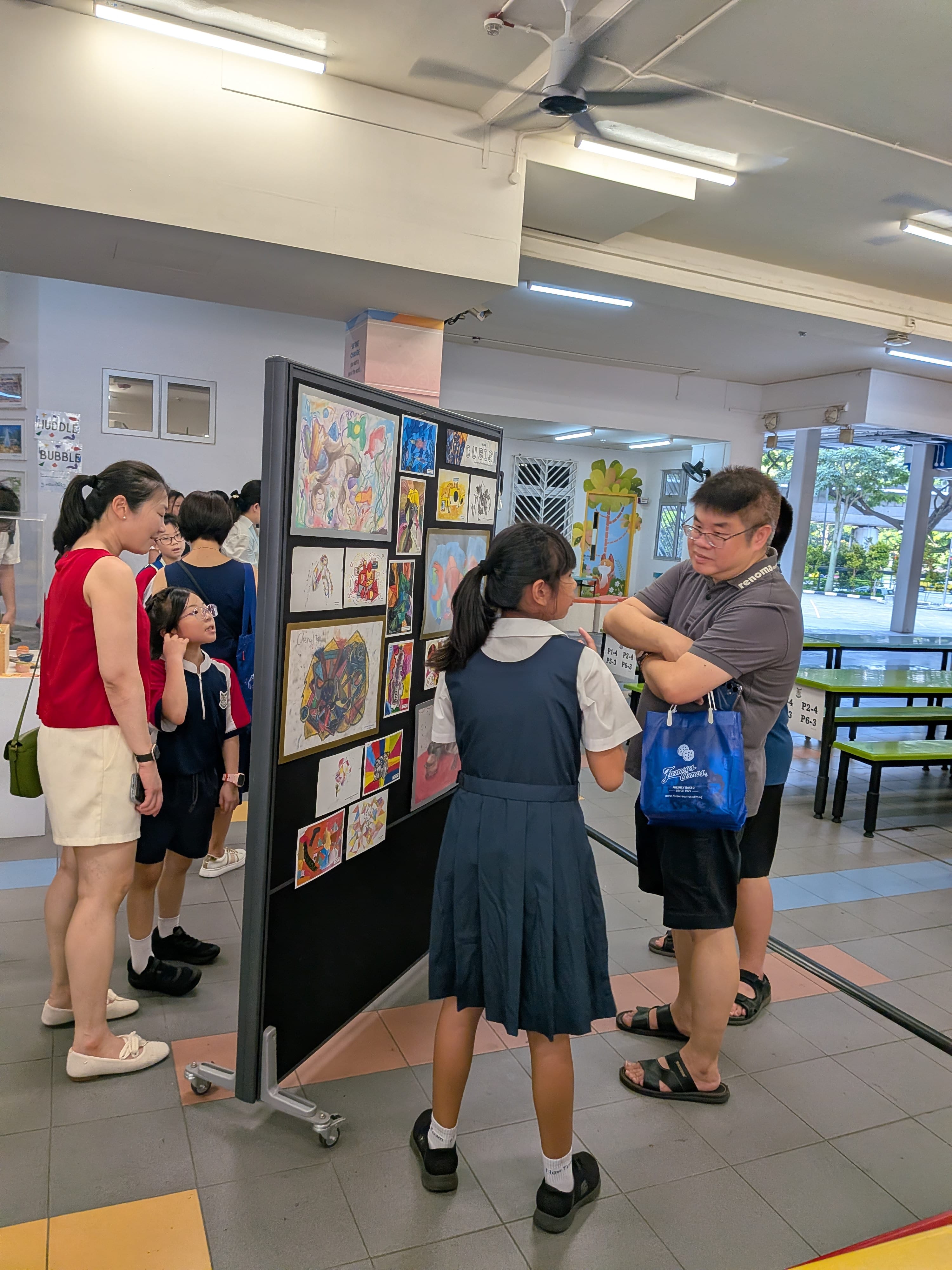 Students demonstrating to visiting parents their Art and Craft works